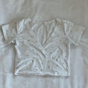 White cropped top with little pink flowers. Good quality!